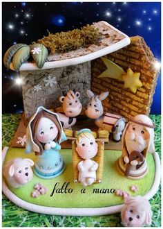 a nativity scene with figurines in the foreground and stars above it