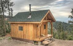 a small wooden cabin sitting on top of a hill