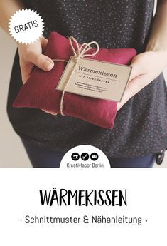 a woman holding a wrapped present in her hands with the words warmweissen on it