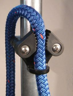 a close up of a metal pole with a blue rope and two black hooks on it