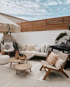 an outdoor living room with wicker furniture