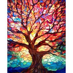 a stained glass tree with colorful leaves on it