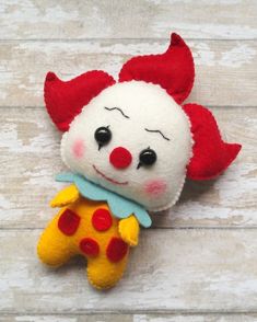 a red and white stuffed animal laying on top of a wooden floor