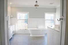 a large white bath tub sitting inside of a bathroom