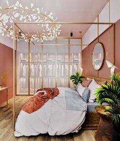 a bedroom with pink walls and white bedding, gold frame headboard, potted plants and mirror on the wall