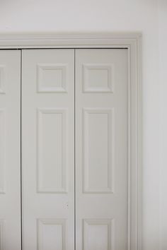 an empty room with white doors and no one in the house or someone is using it