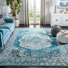 a living room filled with furniture and a blue rug