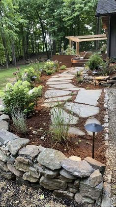 a stone path in the middle of a garden