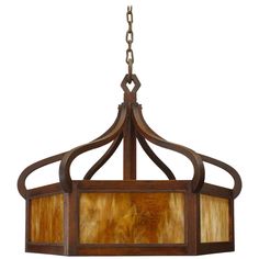 a chandelier hanging from the ceiling with wood and stained glass shades on it