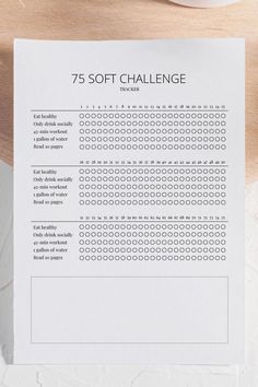 the 75 soft challenge printable on top of a piece of paper next to a cup of coffee