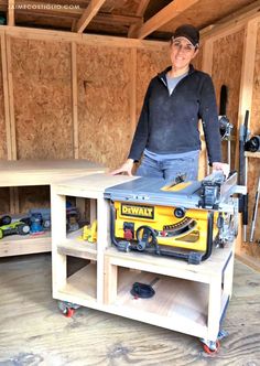 a man standing next to a work bench