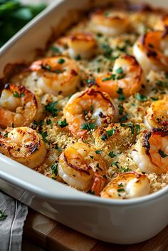 a casserole dish with shrimp and parmesan cheese on the side, ready to be eaten