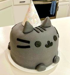 a cat cake with a party hat on top