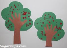 two paper trees cut out to look like children's handprints on them