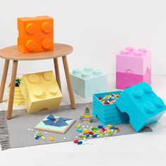 lego blocks and other toys sitting on the floor in front of a small round table