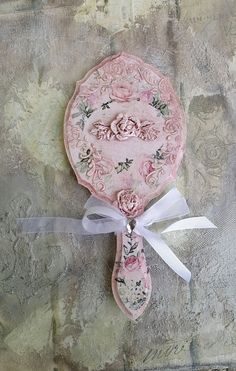 a pink and white plate with flowers on it sitting on top of a piece of paper