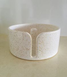 a white bowl with gold speckles on it