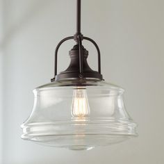 a glass light fixture hanging from a ceiling