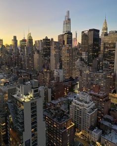 an aerial view of the city skyline at night with skyscrapers in the foreground