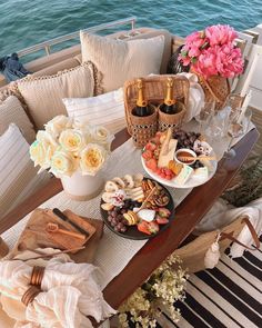 a table filled with food and drinks on top of a boat