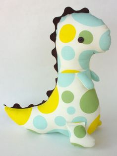 a stuffed giraffe toy sitting on top of a white table next to a wall