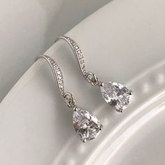 Our best selling Avery earrings are now available in a smaller size!DETAILS:- Available in silver, gold or rose gold - 1" length- .25" width- Stone measures 10mm x 7mm- Lightweight, easy to wear- Nickel and lead free- Securely packaged in a signature gift box- Easy returnsSHOP THE COLLECTION:https://www.etsy.com/shop/TigerlillyCouturePACKAGING:Arrives in a custom Tigerlilly box, perfect for gifting and storing the jewelry.Printed receipts are not included in the box. You may print a receipt dire Teardrop Sterling Silver Crystal Earrings For Wedding, Silver Pear-shaped Teardrop Earrings For Wedding, Sterling Silver Bridal Earrings With Sparkling Teardrop Stones, Sterling Silver Teardrop Bridal Earrings With Sparkling Stones, Sparkling Teardrop Sterling Silver Bridal Earrings, Gold Bridesmaid Necklace, Rose Gold Earrings Wedding, Gold Necklace Wedding, Teardrop Bridal Earrings