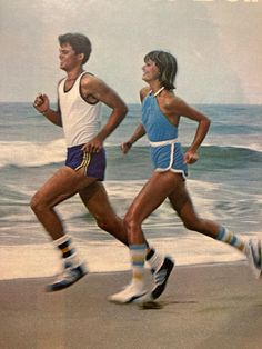 two people running on the beach in front of an advertisement for sportwear and socks