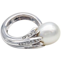 This exceptional ring showcases an 18-karat white gold shank that elegantly wraps around the finger like a stem. From this stem, leaves set with sparkling diamonds cradle a beautiful drop-shaped South Sea pearl measuring 12x16mm. The white pearl's high luster and smooth, blemish-free surface contribute to its luxurious appearance, making it a standout feature of the ring. The overall design combines the elegance of nature-inspired elements with the luxury of fine jewellry, making this ring a tim Pearl Cocktail Ring, Gold Pearl Ring, Pearl And Diamond Ring, Sea Pearl, Diamond Star, Star Jewelry, Diamonds And Gold, South Sea Pearls, Sea Pearls