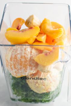 a blender filled with fruits and vegetables on top of a table