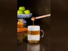 a cup filled with liquid sitting on top of a counter