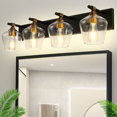 a bathroom vanity with three lights and a mirror