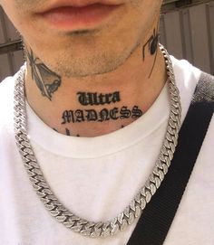 a man with a chain around his neck has a tattoo on his chest that says ultra marines