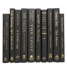 a row of black books sitting on top of each other