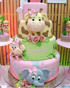 a baby shower cake with an elephant and giraffe on it's side