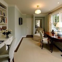 a living room filled with furniture and a flat screen tv sitting on top of a wooden desk