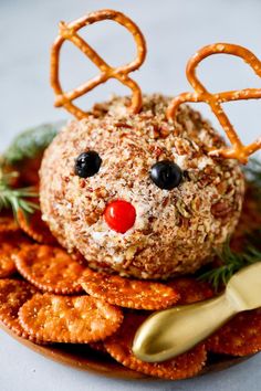 a close up of a plate of food with pretzels and reindeer face on it