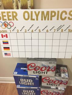 a pile of beer cans sitting on top of a wooden floor next to a sign