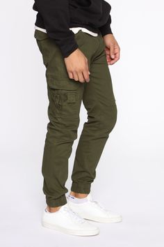 Available In Black, Khaki, Olive, And Camouflage Button Closure Zip Fly Cargo Pants Elastic Hem 31 Inseam 98% Cotton 2% Spandex Imported | Mens Kryptonite Cargo Pants in Olive Green size 32 by Fashion Nova Cotton Cargo Combat Bottoms, Cotton Combat Cargo Bottoms, Combat Cotton Trousers, Combat Style Cotton Trousers, Green Joggers With Pockets For Fall, Fall Green Joggers With Pockets, Combat Cotton Pants With Hip Pockets, Relaxed Fit Khaki Combat Pants, Relaxed Fit Combat Pants In Khaki