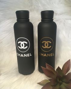 two black water bottles sitting next to each other on a white furnishing area