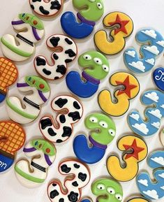 decorated cookies are arranged in the shape of letters and numbers for children's birthdays