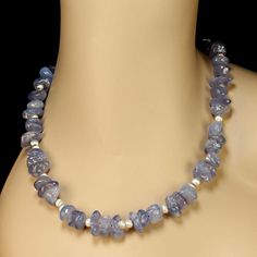 This is part of Chairish’s Costume Jewelry assortment.  Fabulous 24-Inch Polished Blue Chalcedony Nugget Necklace with Sterling Silver Accents  This stunning 24-inch necklace showcases highly polished blue chalcedony nuggets (10x10mm) that glow with a soft, serene radiance. The natural beauty of the chalcedony is enhanced by brushed silver-tone accents, adding texture and elegance to the design.  The necklace is secured with a hammered sterling silver toggle clasp, blending artisan craftsmanship Elegant Chalcedony Jewelry With Polished Beads, Nugget Necklace, Hammered Sterling Silver, Unique Necklace, Blue Chalcedony, Silver Accents, Toggle Clasp, Costume Jewelry, Blending