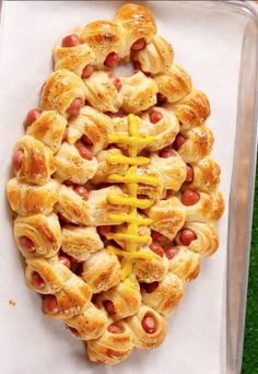 hotdogs wrapped in crescented bread with mustard on them are ready to be eaten