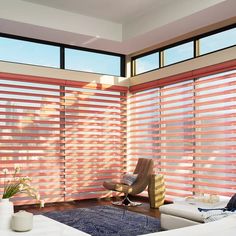 a living room with couches, chairs and blinds in the window sill area