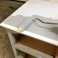 a paint roller is sitting on top of a table that's being worked on