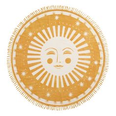 a yellow and white round rug with an image of the sun on it's face