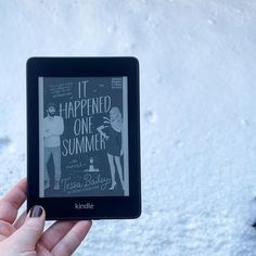 someone is holding up a kindle book in the snow