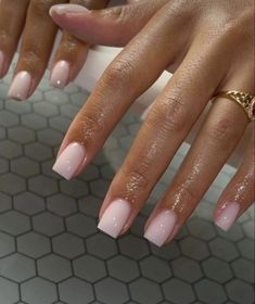 a woman's hands with pink manies and gold rings on their fingertipss