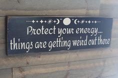 a sign that says protect your energy things are getting weird out there on the wall