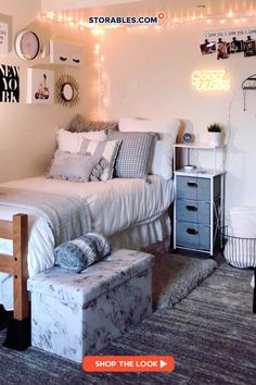 a bed room with a neatly made bed and lots of lights on the wall above it