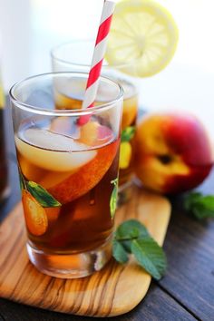 two glasses filled with iced tea and fruit